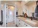 Modern bathroom featuring double sinks, quartz countertop, and an adjacent tub shower at 2132 Ponticino St, Henderson, NV 89044