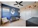 Charming bedroom featuring a celestial themed accent wall, crib, and closet at 2132 Ponticino St, Henderson, NV 89044