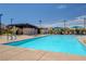 Inviting community pool area with comfortable lounge seating and shade umbrellas in Inspirada at 2132 Ponticino St, Henderson, NV 89044