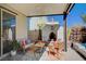 This relaxing covered patio showcases comfortable seating, an outdoor fireplace, and stylish decor at 2132 Ponticino St, Henderson, NV 89044