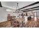 Well-lit dining room with an eat-in kitchen, wood floors and neutral wall colors at 2132 Ponticino St, Henderson, NV 89044
