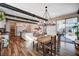 Bright dining room area with wood floors, a stylish chandelier and stainless appliances at 2132 Ponticino St, Henderson, NV 89044