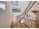 Bright foyer with wood floors, open staircase and charming, antique chest at 2132 Ponticino St, Henderson, NV 89044