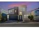 Modern two-story home featuring a dark gray garage door and stylish front door at 2132 Ponticino St, Henderson, NV 89044