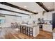 Open-concept eat-in kitchen with stainless steel appliances, large island, and wood beam details at 2132 Ponticino St, Henderson, NV 89044