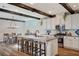 Eat-in kitchen features bright white cabinets, a large island and rustic wood beam details at 2132 Ponticino St, Henderson, NV 89044