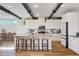 Modern kitchen features stainless steel appliances, a breakfast bar, and white cabinetry at 2132 Ponticino St, Henderson, NV 89044
