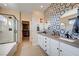 Elegant bathroom featuring dual sinks, stylish tile work, glass shower, and walk-in closet at 2132 Ponticino St, Henderson, NV 89044