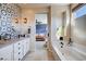 Luxurious main bathroom featuring dual vanities, a soaking tub, and patterned accent wall at 2132 Ponticino St, Henderson, NV 89044