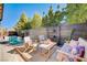 A cozy patio features stylish seating, a wooden fence, and a refreshing plunge pool for outdoor relaxation at 2132 Ponticino St, Henderson, NV 89044