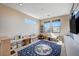 A spacious playroom featuring a star and moon rug, natural light, and built-in storage at 2132 Ponticino St, Henderson, NV 89044