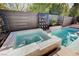 The sparkling pool and spa feature modern tilework, providing a luxurious outdoor oasis at 2132 Ponticino St, Henderson, NV 89044