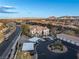 Aerial view of the home with mature landscaping, a large parking area, and a view of mountains in the distance at 2325 Windmill Pkwy # 1711, Henderson, NV 89074