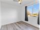 Bright bedroom showcasing a large window, neutral walls, and modern wood-look flooring at 2325 Windmill Pkwy # 1711, Henderson, NV 89074