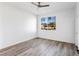 Inviting bedroom with wood floors, a ceiling fan, and a bright window showcasing neighborhood views at 2325 Windmill Pkwy # 1711, Henderson, NV 89074