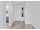 Bright entryway featuring light gray wood flooring, white walls, and a front door leading into the home at 2325 Windmill Pkwy # 1711, Henderson, NV 89074