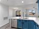 Modern kitchen with blue cabinets, stainless steel appliances, marble countertops, and light gray wood flooring at 2325 Windmill Pkwy # 1711, Henderson, NV 89074