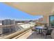 Outdoor patio boasts city views with table, chairs, and sun shade, perfect for entertaining at 2877 Paradise Rd # 2203, Las Vegas, NV 89109