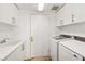 Convenient laundry room featuring a utility sink, washer, and dryer at 2877 Paradise Rd # 2203, Las Vegas, NV 89109