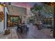 Inviting back patio with wood floors, stone accents, barbecue, and string lights for outdoor dining at 3069 Lascari Ave, Henderson, NV 89044