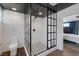 Bathroom featuring a black framed glass shower, white subway tile, and view into bedroom with a king bed at 3069 Lascari Ave, Henderson, NV 89044