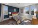 Stylish bedroom featuring a queen bed, blue accent wall, and plenty of natural light from multiple windows at 3069 Lascari Ave, Henderson, NV 89044