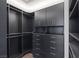 Spacious walk-in closet featuring dark wood cabinets, shelves, and drawers for optimal organization at 3069 Lascari Ave, Henderson, NV 89044