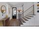 Stylish foyer with wood floors, staircase, and modern decor at 3069 Lascari Ave, Henderson, NV 89044