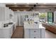 Modern kitchen with stainless steel appliances, island, and access to backyard at 3069 Lascari Ave, Henderson, NV 89044