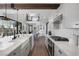 Modern kitchen boasts stainless appliances, marble counters, white cabinets, and wood flooring at 3069 Lascari Ave, Henderson, NV 89044