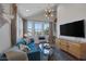 Stylish living room with modern furniture, large windows, and a decorative light fixture at 3069 Lascari Ave, Henderson, NV 89044