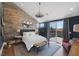 Stylish main bedroom with wood accent wall and private balcony access at 3069 Lascari Ave, Henderson, NV 89044