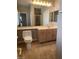 Well-lit bathroom featuring a spacious vanity with a large mirror and ample lighting at 332 Wild Plum Ln, Las Vegas, NV 89107