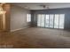 Spacious living room featuring large windows and neutral carpeting at 332 Wild Plum Ln, Las Vegas, NV 89107