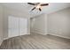 Spacious bedroom with a ceiling fan, wood floors and a closet at 3428 Royal Calloway Ave, Las Vegas, NV 89141