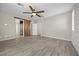 Large bedroom featuring wood floors, barn door and access to an ensuite at 3428 Royal Calloway Ave, Las Vegas, NV 89141