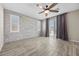 Bright bedroom with a decorative wall and wood look floors at 3428 Royal Calloway Ave, Las Vegas, NV 89141