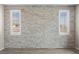 Bedroom accent wall with stacked stone detail and bright windows at 3428 Royal Calloway Ave, Las Vegas, NV 89141