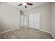 Spacious bedroom with wood-style flooring, a ceiling fan, and closet space, providing comfort and functionality at 3428 Royal Calloway Ave, Las Vegas, NV 89141