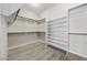 Spacious walk-in closet with custom shelving and wood floors, offering ample storage and organization at 3428 Royal Calloway Ave, Las Vegas, NV 89141