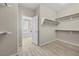 Walk-in closet featuring a glimpse into a bathroom with a soaking tub, adding a touch of luxury and convenience at 3428 Royal Calloway Ave, Las Vegas, NV 89141