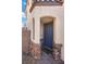 Covered front entry with stone accents and a colorful doormat at 3428 Royal Calloway Ave, Las Vegas, NV 89141