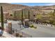 Community gated entrance featuring desert landscaping, stone pillars, and privacy for residents at 3428 Royal Calloway Ave, Las Vegas, NV 89141