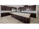 A spacious kitchen features a large center island, stainless steel appliances, and dark cabinetry at 3428 Royal Calloway Ave, Las Vegas, NV 89141