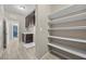 Well-lit laundry room with ample storage and easy access to the bathroom at 3428 Royal Calloway Ave, Las Vegas, NV 89141