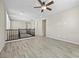 Spacious living room boasts wood-style tile flooring and a ceiling fan at 3428 Royal Calloway Ave, Las Vegas, NV 89141
