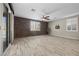 Living room with brick accent wall, ceiling fan, and sliding doors to the exterior at 3428 Royal Calloway Ave, Las Vegas, NV 89141