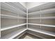 A walk-in pantry features ample shelving space for organized storage and supplies at 3428 Royal Calloway Ave, Las Vegas, NV 89141
