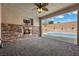 Covered patio features a stone fireplace and a view of the pool and outdoor area at 3428 Royal Calloway Ave, Las Vegas, NV 89141