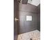 Stunning shower featuring dark textured tile, a rain shower head, and a mosaic tile niche for added luxury at 3428 Royal Calloway Ave, Las Vegas, NV 89141